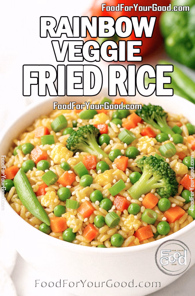 Rainbow Veggie Fried Rice in a white ceramic bowl with broccoli, carrots, peas, snap peas, and scrambled eggs on a marble countertop, styled for FoodForYourGood.com