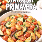 Roasted Gnocchi Primavera served in a white bowl with zucchini, cherry tomatoes, bell peppers, and onions, FoodForYourGood.com