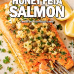 Roasted Honey Feta Salmon fillet, topped with golden baked feta, honey, and capers, with a fork flaking tender salmon and fresh parsley garnish – FoodForYourGood.com