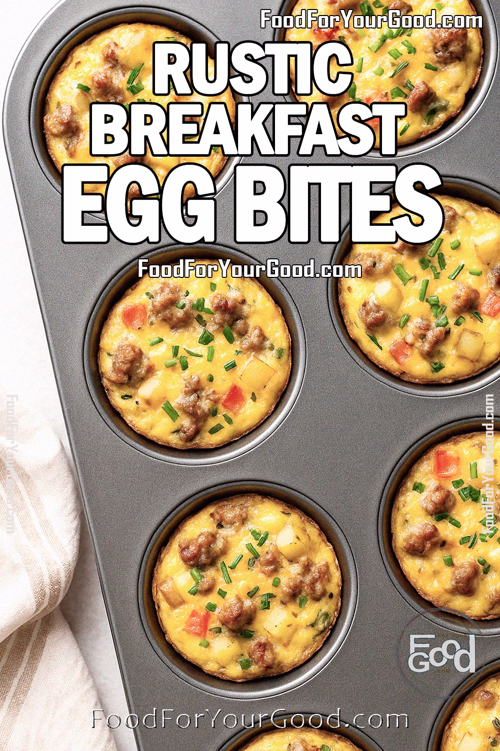 Rustic Breakfast Egg Bites Recipe – FoodForYourGood.com Rustic Breakfast Egg Bites baked golden brown in a muffin tin, filled with sausage, potatoes, cheddar cheese, and fresh chives, set on a marble surface with a soft white towel.