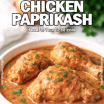 Rustic Hungarian Chicken Paprikash served in a white bowl with creamy paprika sauce, garnished with fresh parsley on FoodForYourGood.com