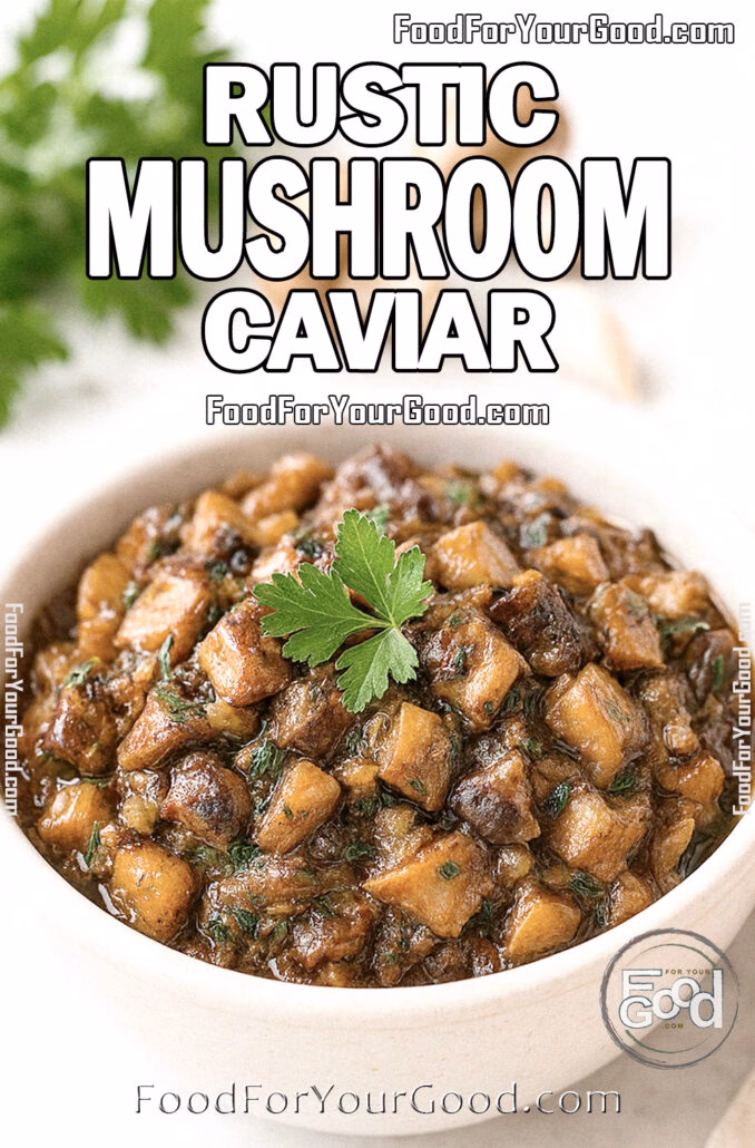 Rustic Mushroom Caviar in a white ceramic bowl on marble countertop with fresh parsley garnish, mushrooms, and garlic in the background on FoodForYourGood.com