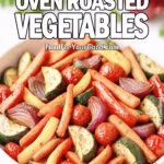 Rustic Oven Roasted Vegetables served in a white ceramic dish with zucchini, carrots, peppers, onion, and cherry tomatoes on FoodForYourGood.com