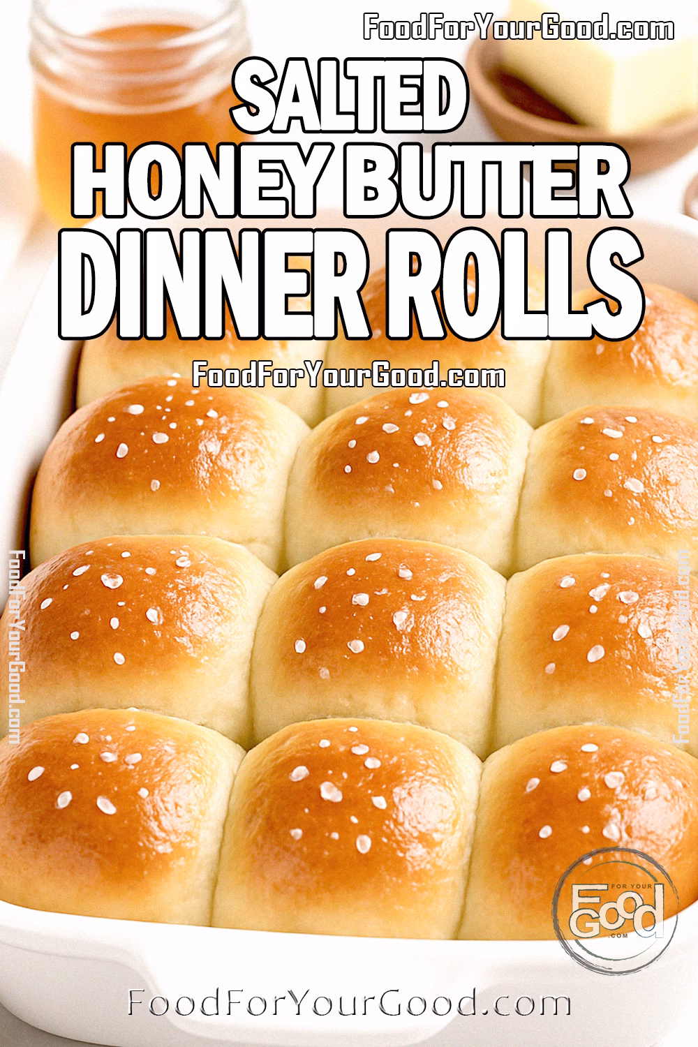 Salted Honey Butter Dinner Rolls in a white baking dish on marble with honey, butter, and flaky sea salt.