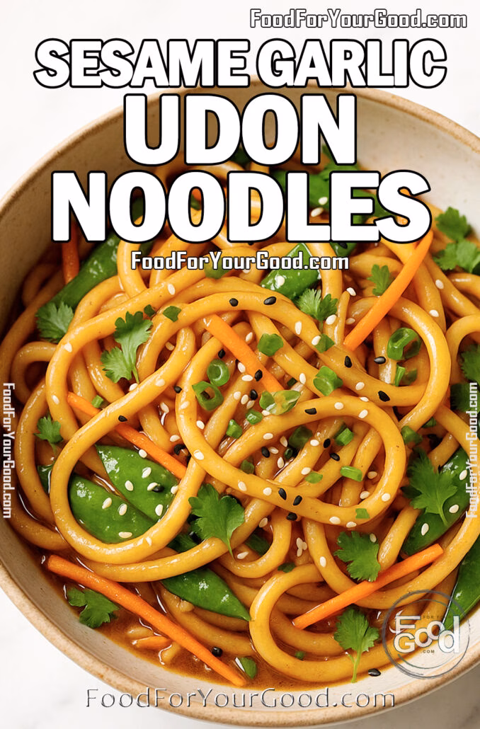 A bowl of sesame garlic udon noodles with carrots, snow peas, and fresh herbs on a white marble surface.