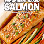 Sesame Ginger Parchment-Baked Salmon with tender vegetables and lime wedges on a round white plate.