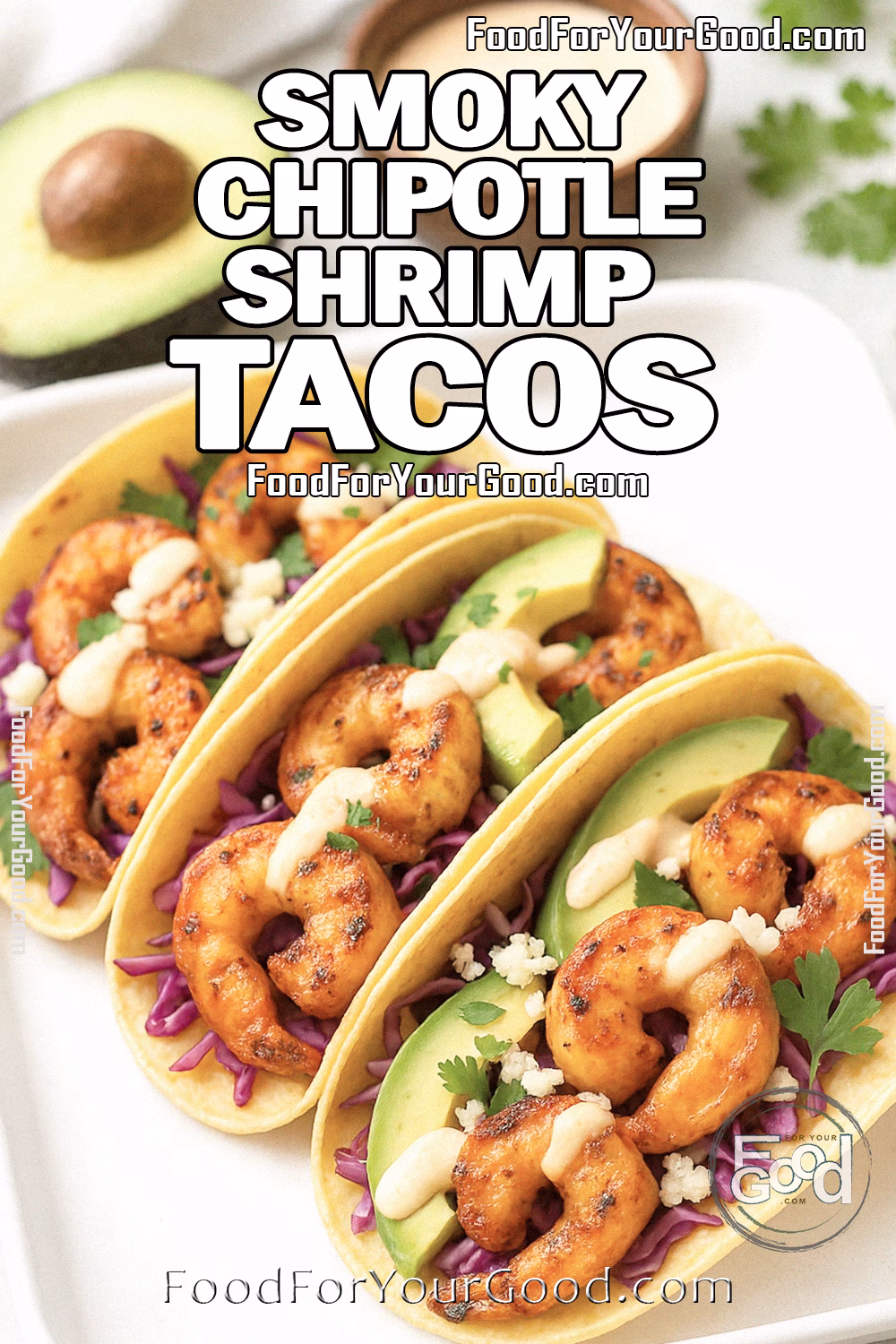 Smoky Chipotle Shrimp Tacos Recipe | FoodForYourGood.com Smoky Chipotle Shrimp Tacos with avocado, red cabbage, cotija cheese, and chipotle-lime crema on a white rectangular plate from FoodForYourGood.com