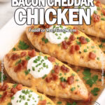 Smothered Bacon Cheddar Chicken baked golden in a white dish, topped with melted cheese, crispy bacon, sour cream, and green onions on FoodForYourGood.com.