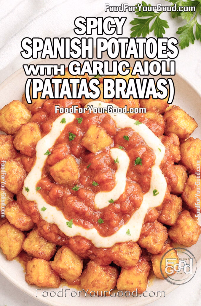 Spicy Spanish Potatoes with Garlic Aioli (Patatas Bravas) Spicy Spanish Potatoes with Garlic Aioli (Patatas Bravas) served in a white ceramic dish on marble with parsley garnish.