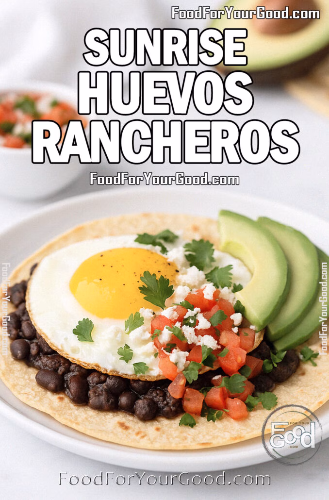 Sunrise Huevos Rancheros Sunrise Huevos Rancheros with crispy tortilla, black beans, sunny-side-up egg, fresh salsa, avocado slices, and queso fresco on a white plate over marble.