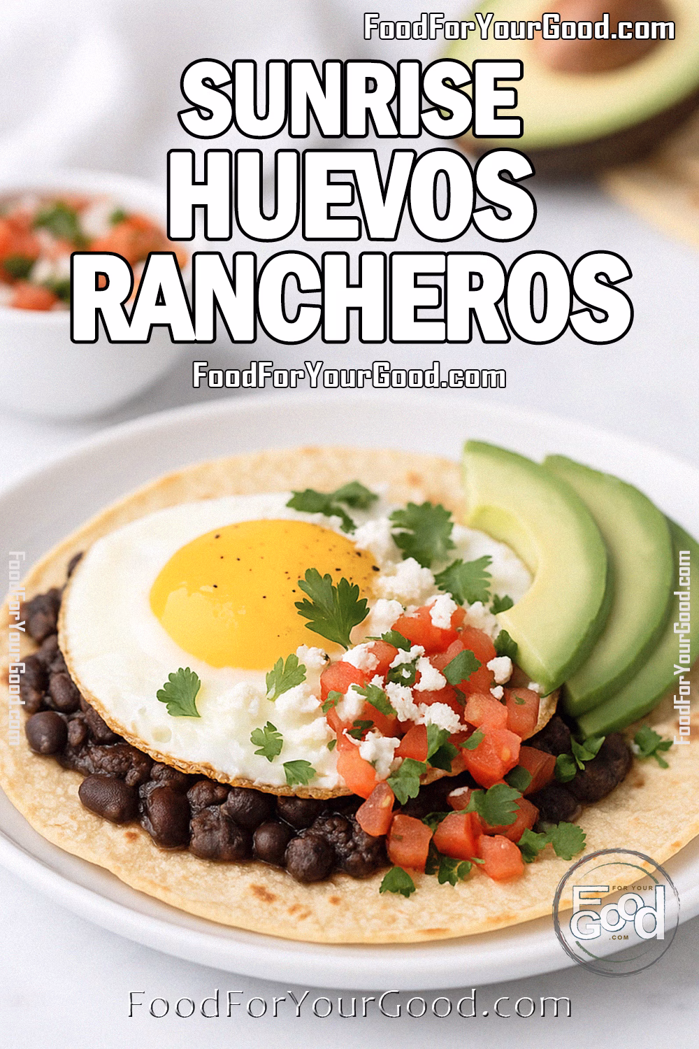 Sunrise Huevos Rancheros Recipe – FoodForYourGood.com Sunrise Huevos Rancheros with crispy tortilla, black beans, sunny-side-up egg, fresh salsa, avocado slices, and queso fresco on a white plate over marble.