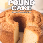 Supreme Butter Pound Cake on a white plate with a naturally cracked, golden crust and airy crumb, served with a pat of butter and cup of tea in the background.