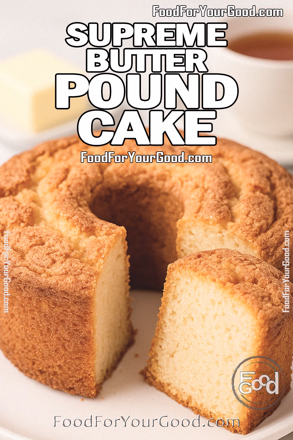 Supreme Butter Pound Cake Recipe – FoodForYourGood.com Supreme Butter Pound Cake on a white plate with a naturally cracked, golden crust and airy crumb, served with a pat of butter and cup of tea in the background.