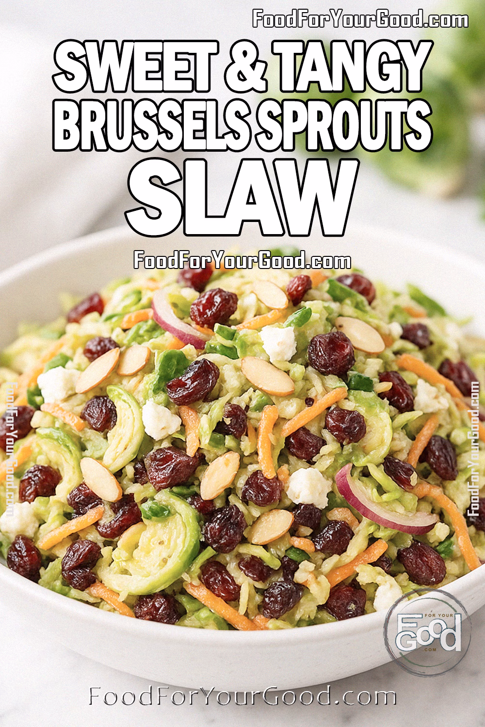Sweet & Tangy Brussels Sprouts Slaw in a white ceramic bowl, topped with almonds, cranberries, and feta. Styled on a marble surface with fresh Brussels sprouts and a white towel in the background.