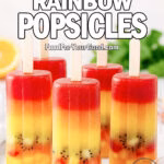 Homemade Tropical Rainbow Popsicles with layers of orange, pineapple, and pomegranate juice, frozen with diced kiwi, strawberry, and mango, displayed on a white marble background.