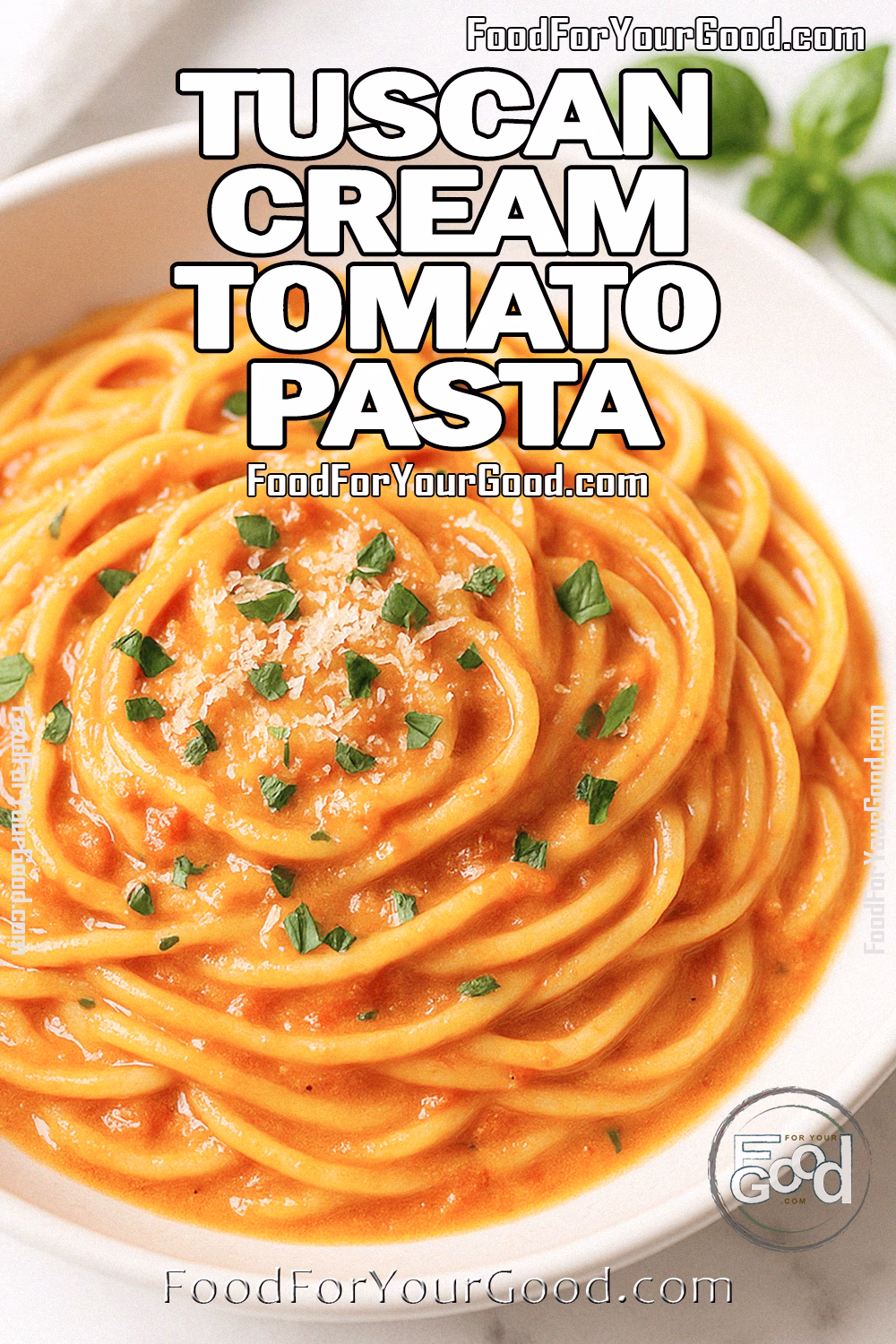 Tuscan Cream Tomato Pasta Recipe – FoodForYourGood.com Tuscan Cream Tomato Pasta served in a white plate on marble background with basil garnish.