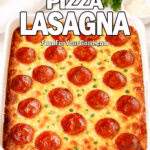 Ultimate Pizza Lasagna in a white ceramic baking dish with golden bubbly cheese, crispy pepperoni, and fresh parsley on top, on marble background.
