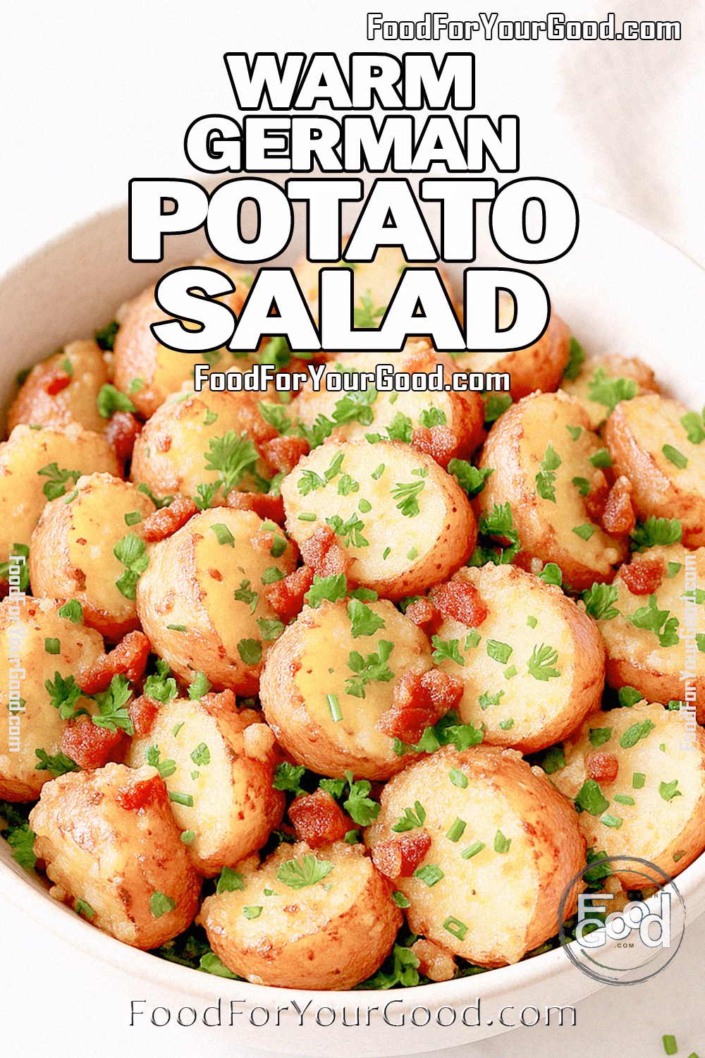 Warm German Potato Salad with bacon vinaigrette and herbs in a white serving bowl