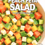 Freshly chopped watermelon peach cucumber salad with feta and basil in a white bowl.