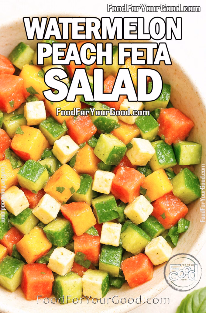 Freshly chopped watermelon peach cucumber salad with feta and basil in a white bowl.