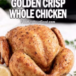 Air Fryer Golden Crisp Whole Chicken served on a white marble tray with lemon and herbs on FoodForYourGood.com