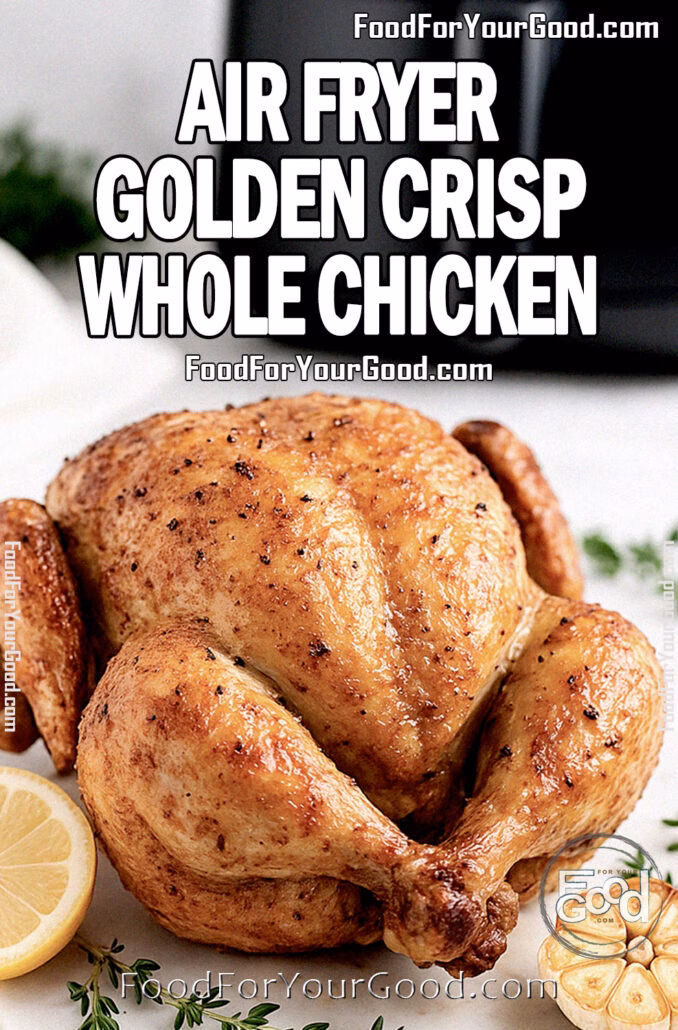 Air Fryer Golden Crisp Whole Chicken served on a white marble tray with lemon and herbs on FoodForYourGood.com
