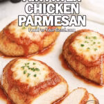 Sliced Crispy Air Fryer Chicken Parmesan topped with marinara and mozzarella on a white marble tray.