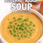 Instant Pot Butternut Squash Soup in a white bowl on marble, garnished with parsley, surrounded by fresh squash, carrots, and apple.